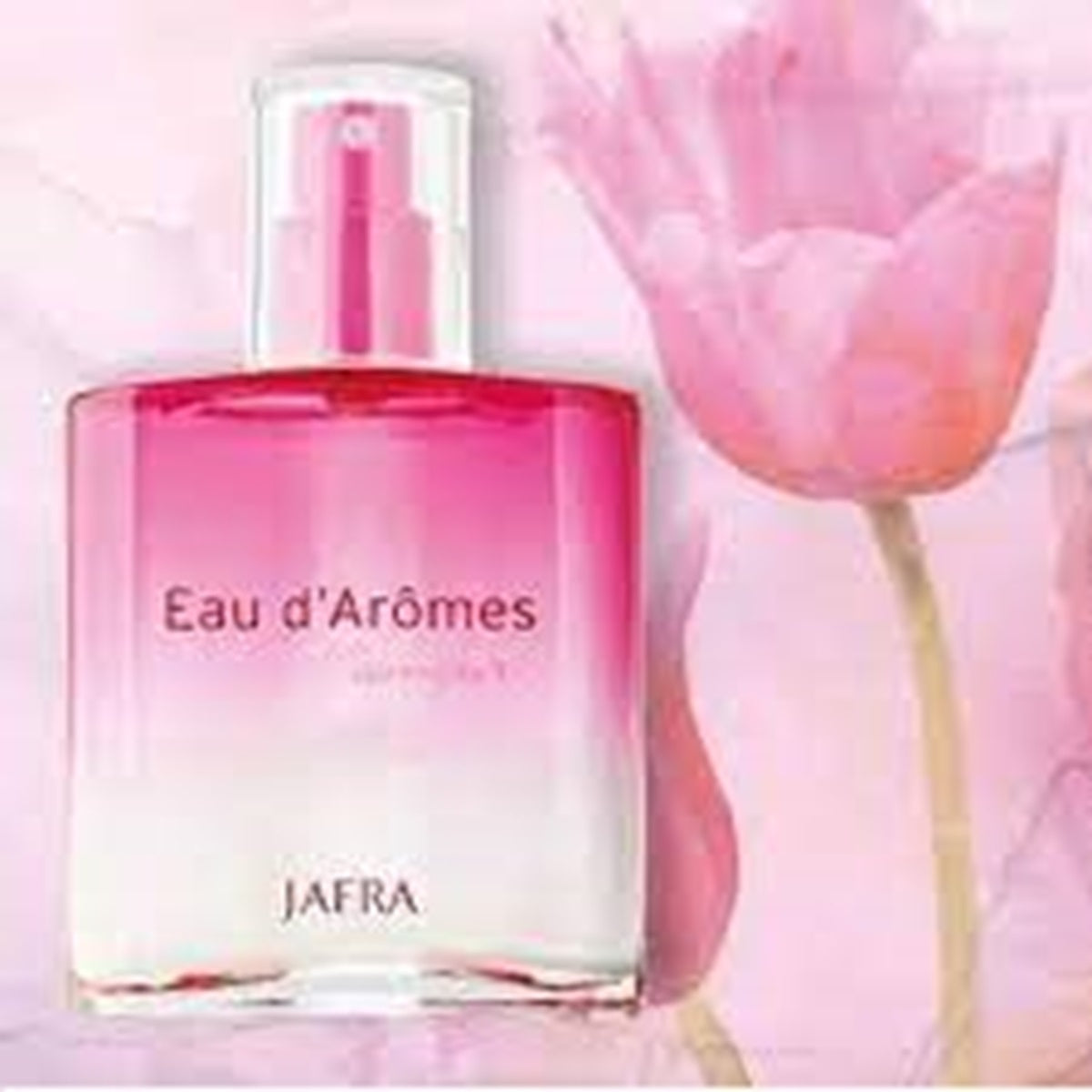 Eau d'Arômes perfume bottle with a pink flower in the background