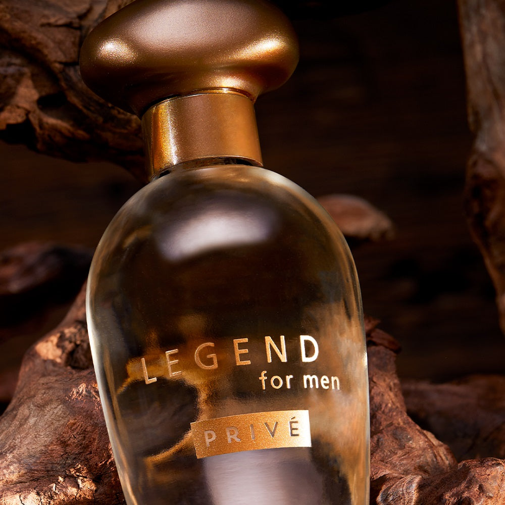 Perfume bottle labeled 'Legend for men Prive' on a wooden background