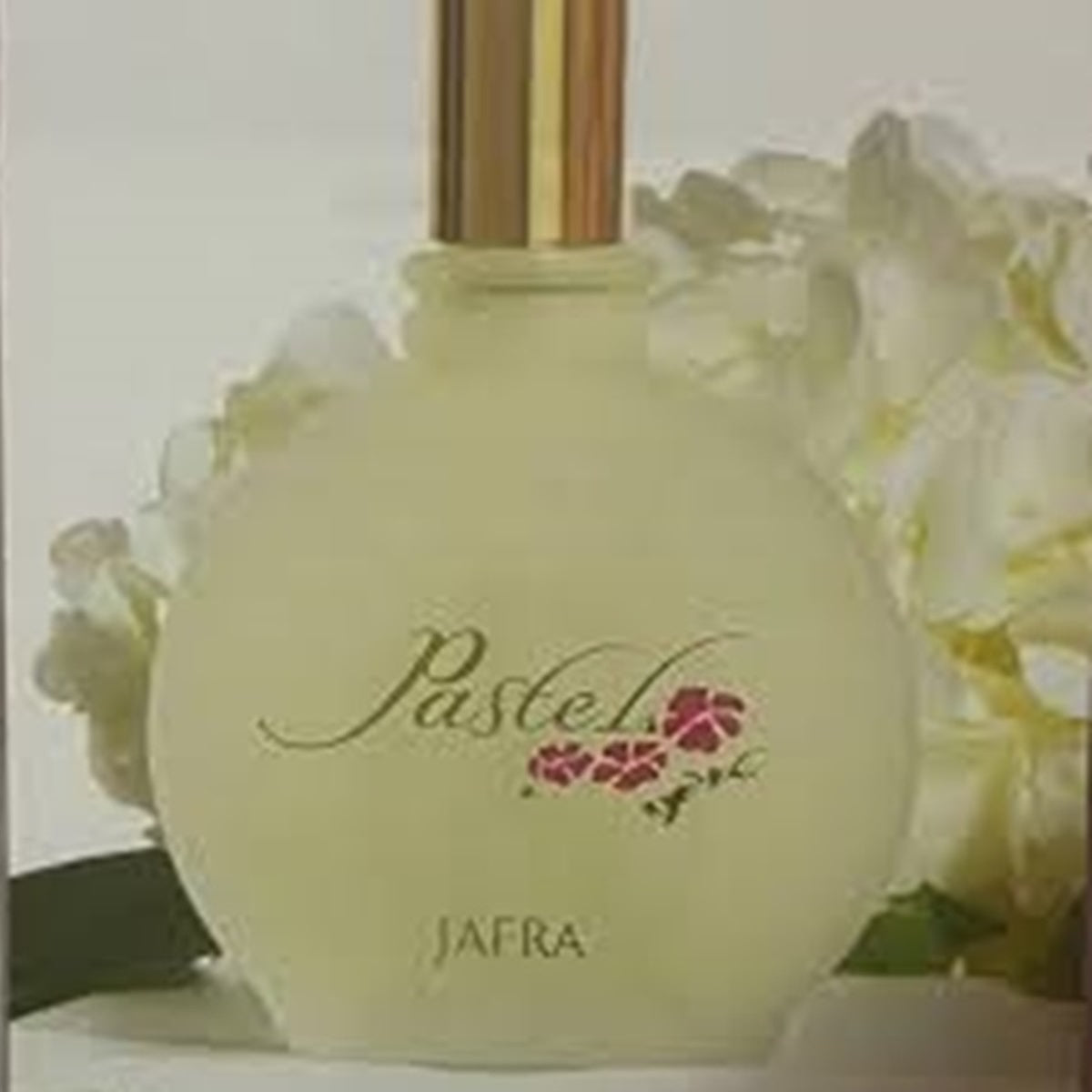 Perfume bottle with floral design and 'JAFRA' branding on a light background