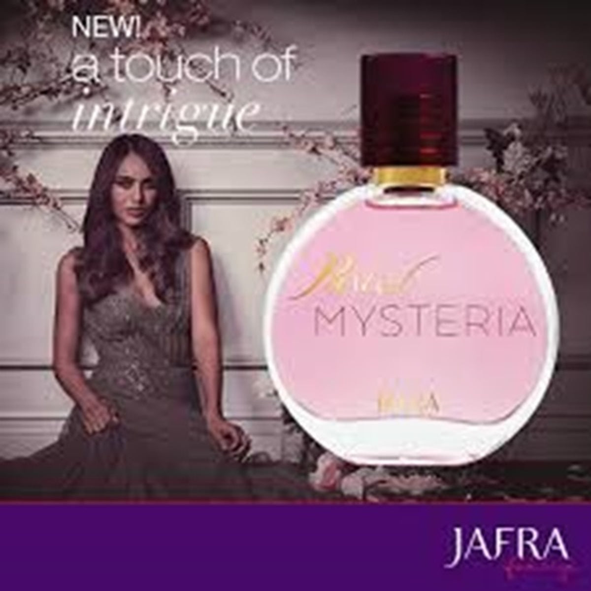 Perfume bottle labeled 'Mysteria' with a woman in a dark dress and floral background, featuring the brand 'Jafra'.