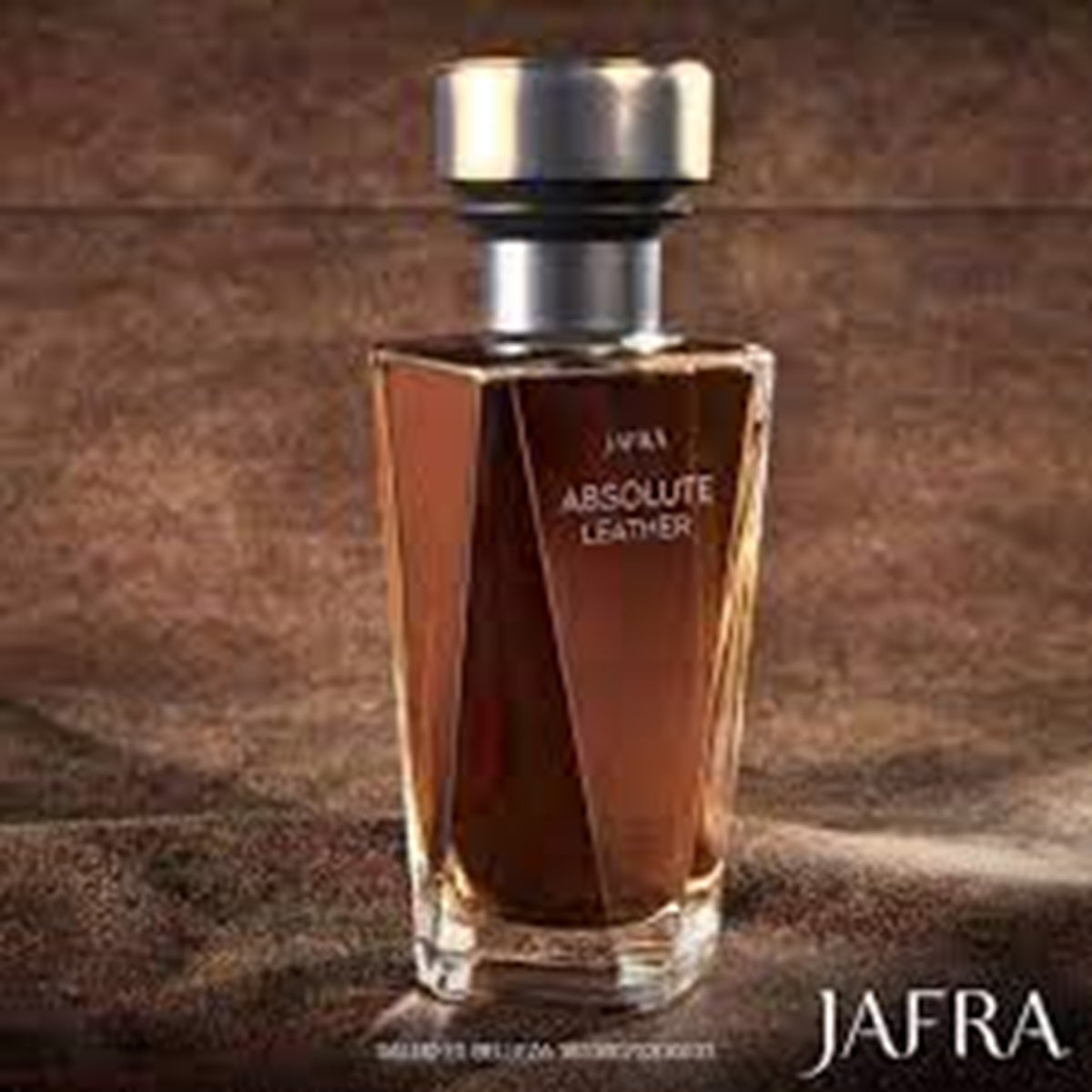 Jafra Absolute Leather perfume bottle on a brown textured background
