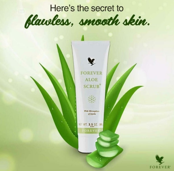 Forever Aloe Scrub with aloe vera leaves on a green background