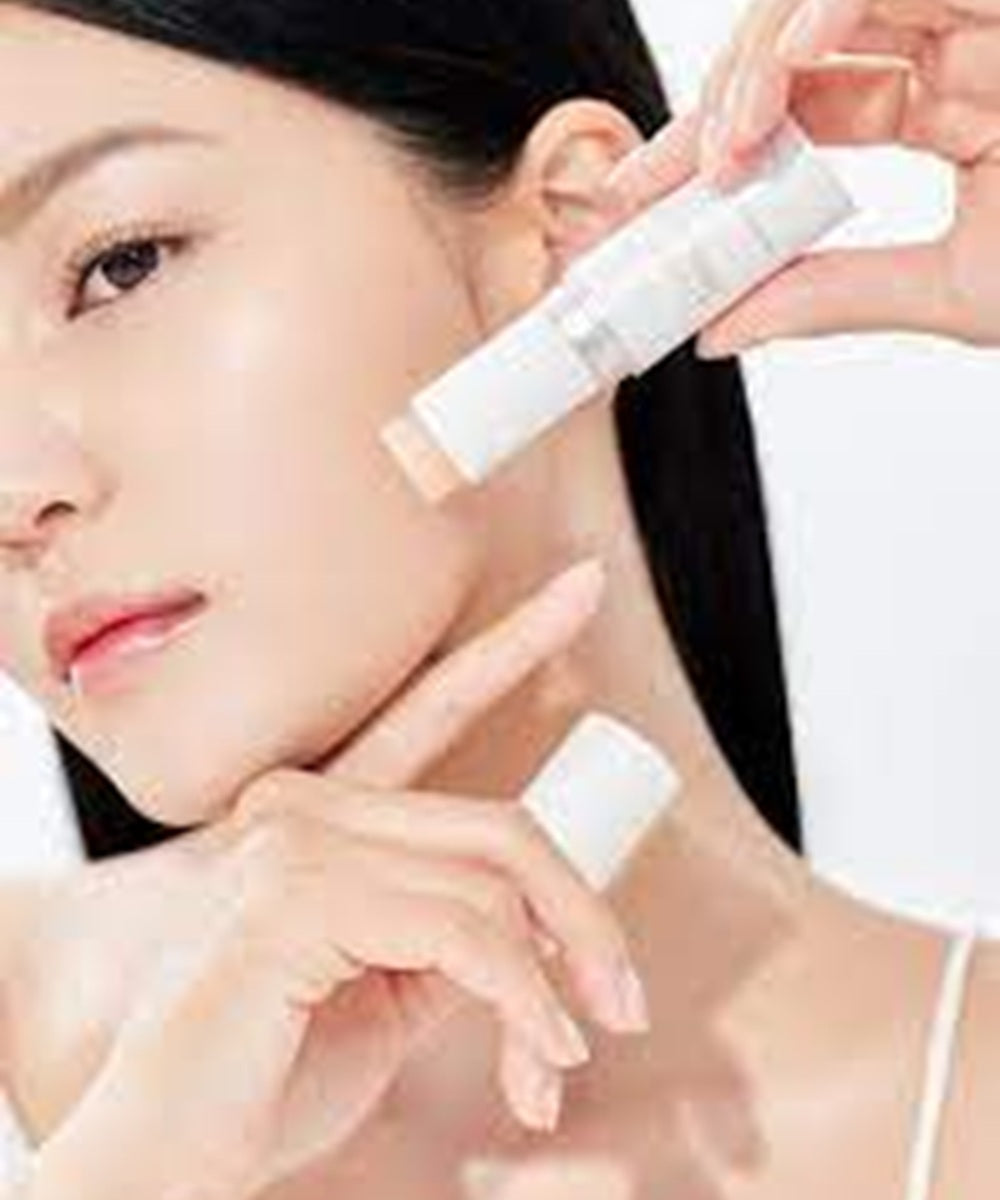 Woman applying a skincare product to her face