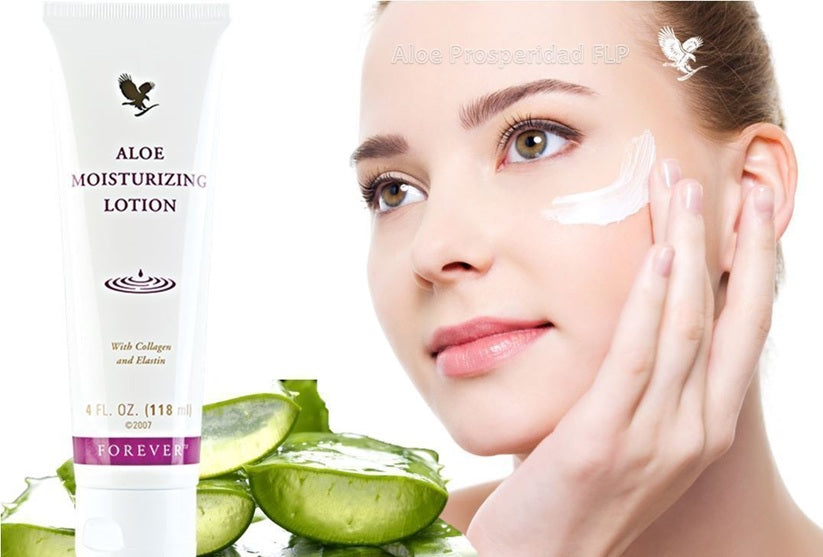 Woman applying aloe moisturizing lotion to her face with a tube of the product and aloe vera leaves in the background.