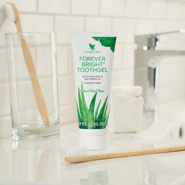 Forever Bright Toothgel tube with a toothbrush on a bathroom counter