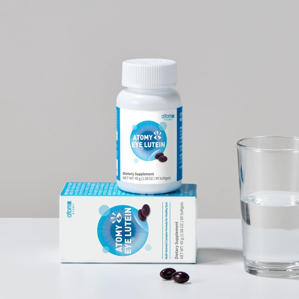 Atom Eye Lutein supplement bottle and packaging on a neutral background with a glass of water.