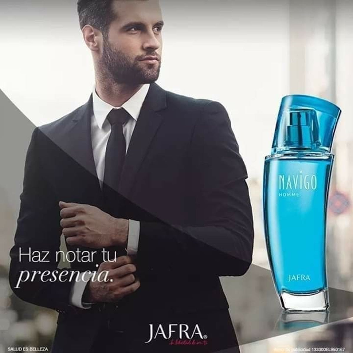 Man in a suit with a blue Jafra Navigo perfume bottle on a blurred background