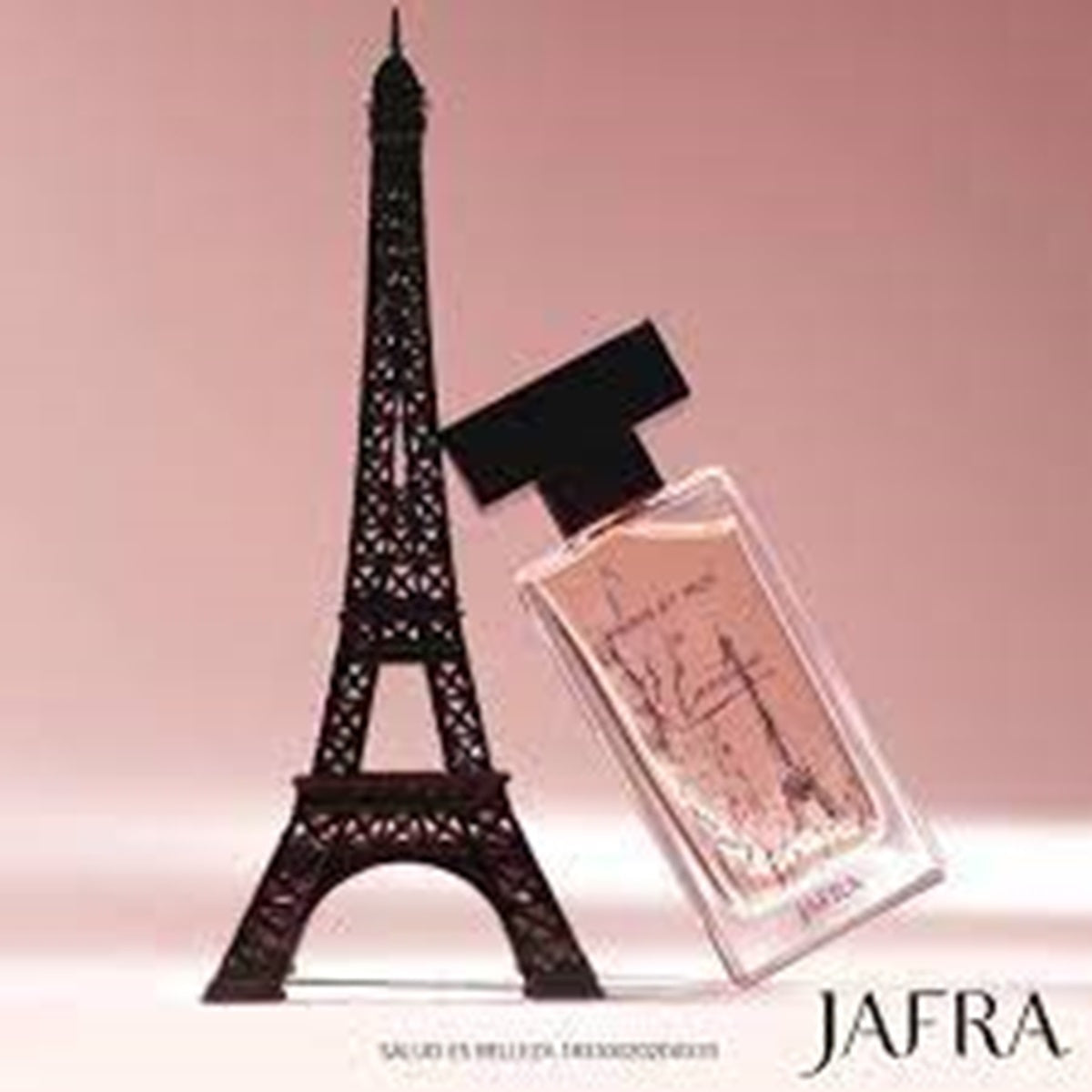 Perfume bottle with Eiffel Tower silhouette on a pink background, featuring the brand 'JAFRA'.