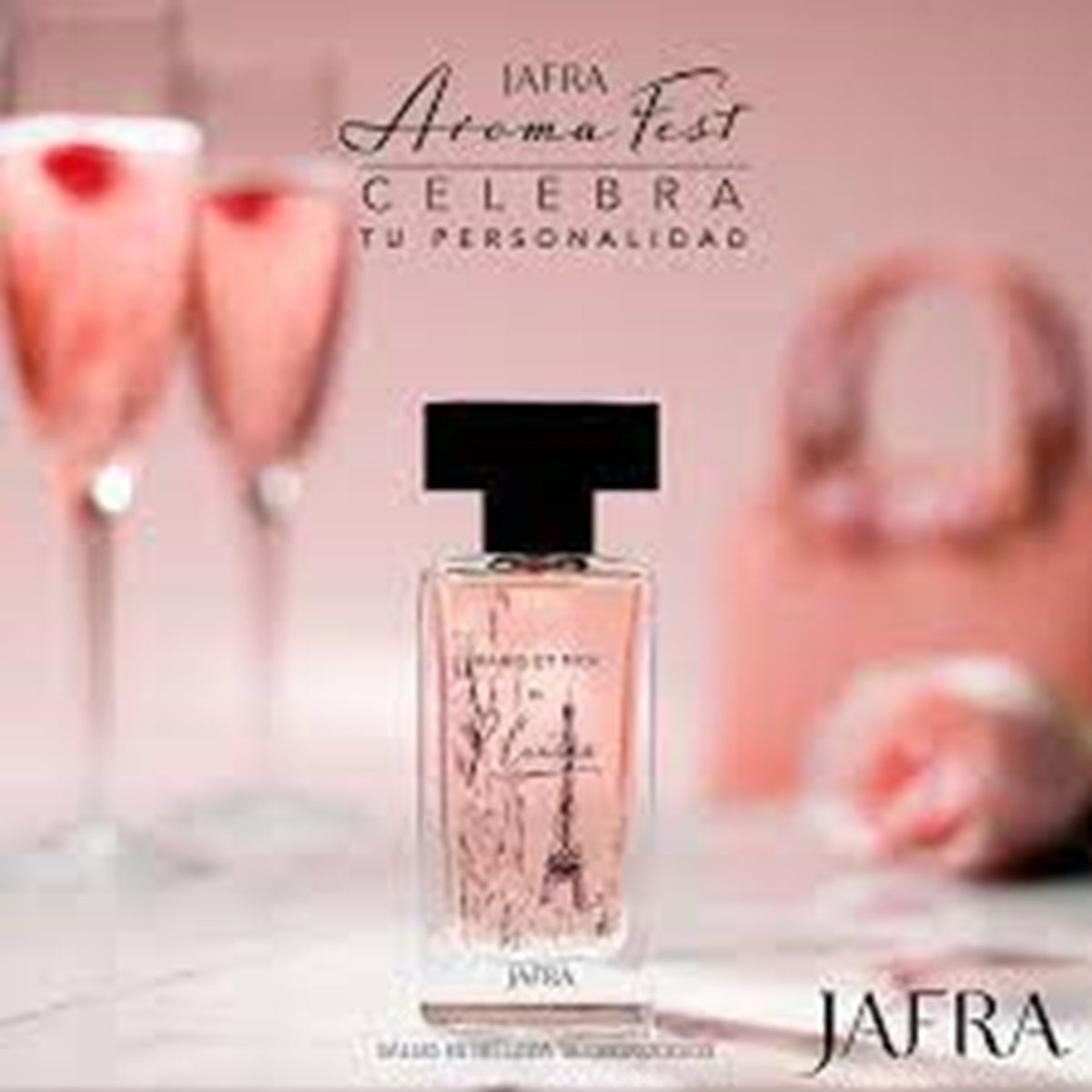 Jafra perfume bottle with champagne flutes and blurred background