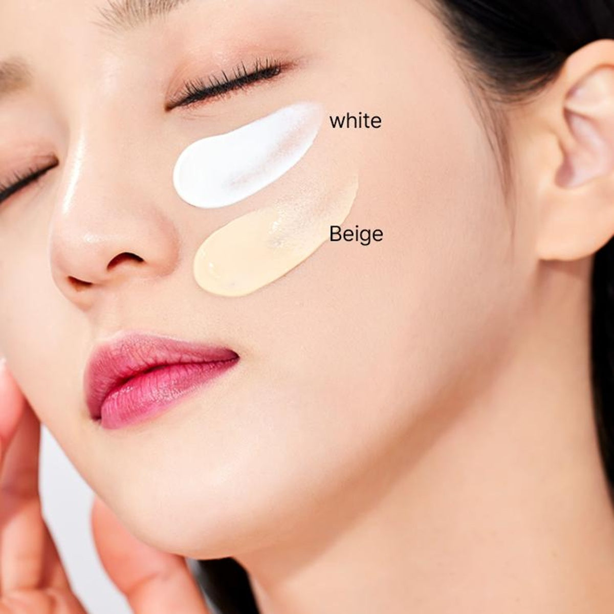 Close-up of a woman's face with white and beige patches on her cheek, labeled with their respective colors.