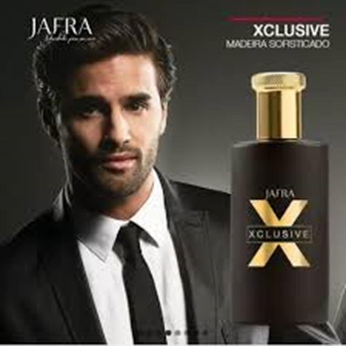 Man in formal attire next to a Jafra Xclusive perfume bottle on a dark background